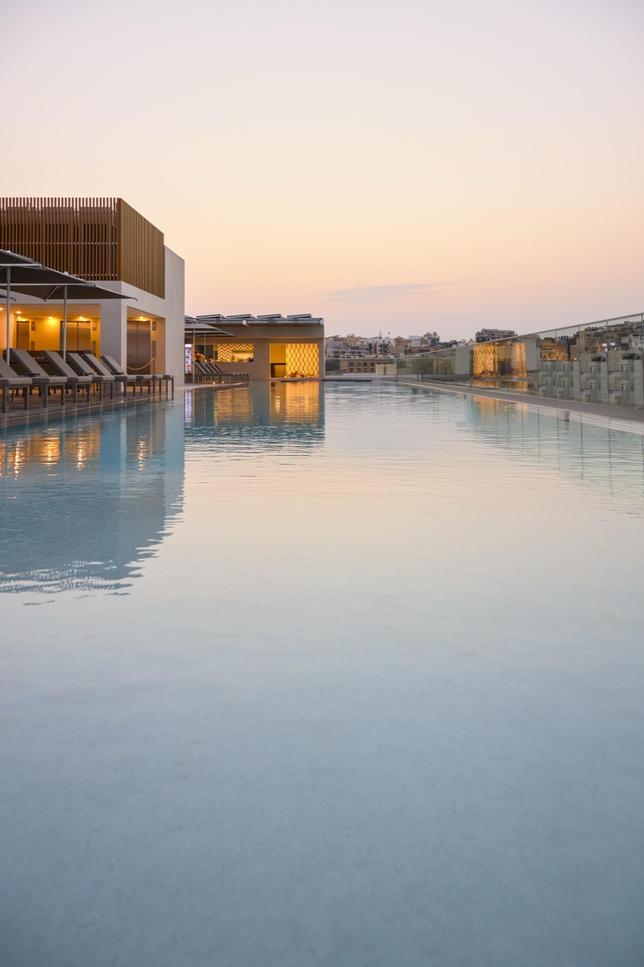 Rooftop pool glowing at twilight